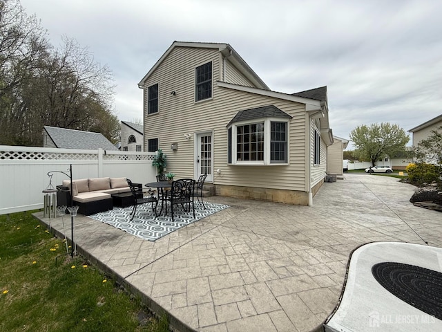 back of property with a patio area, an outdoor hangout area, fence, and central air condition unit