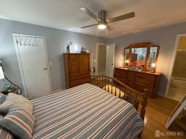 bedroom featuring ceiling fan, baseboards, and wood finished floors