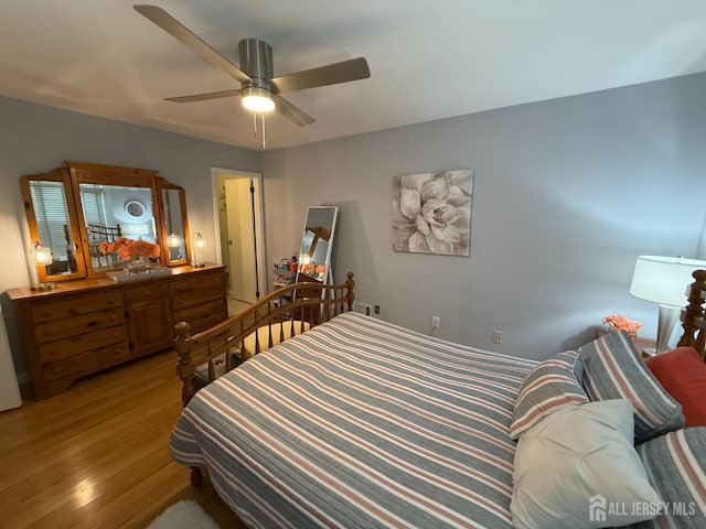 bedroom featuring a ceiling fan and light wood finished floors