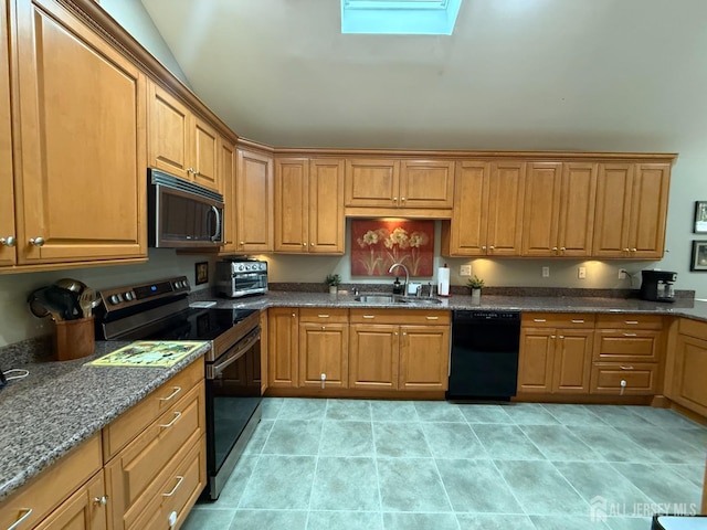 kitchen with dishwasher, stainless steel electric range oven, a sink, dark stone counters, and a skylight