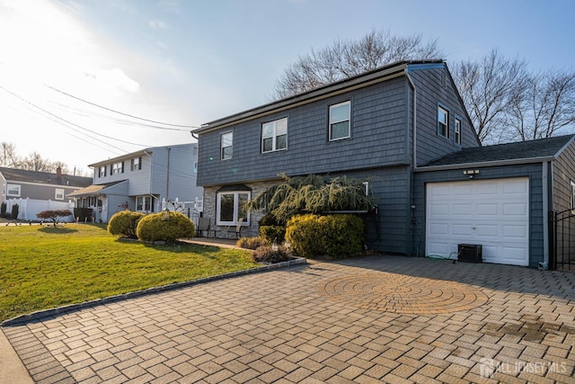 front facade featuring a front lawn and a garage