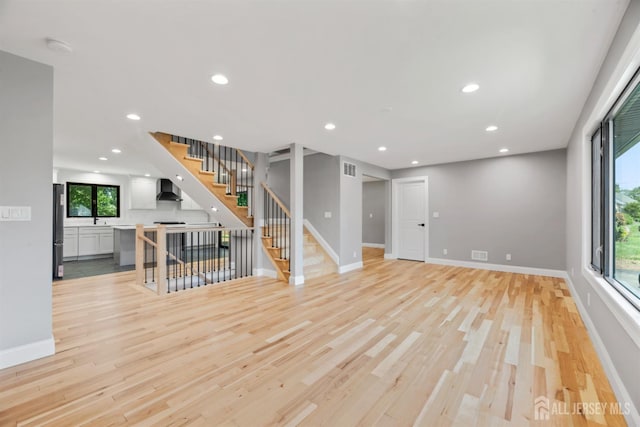 13 Lauretta Dr, East Brunswick, NJ 08816 - unfurnished living room with light wood-type flooring, stairs, and recessed lighting