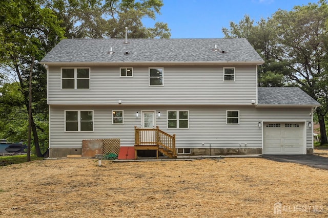 244 Lloyd Rd, Matawan, NJ 07747 - back of house with a garage, driveway, and roof with shingles