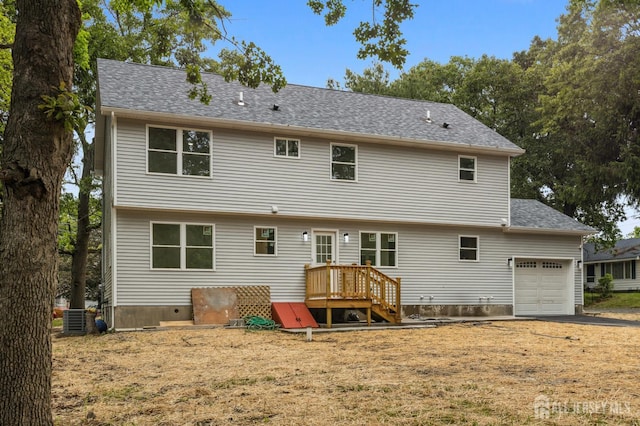244 Lloyd Rd, Matawan, NJ 07747 - rear view of house featuring an attached garage, central AC unit, and roof with shingles