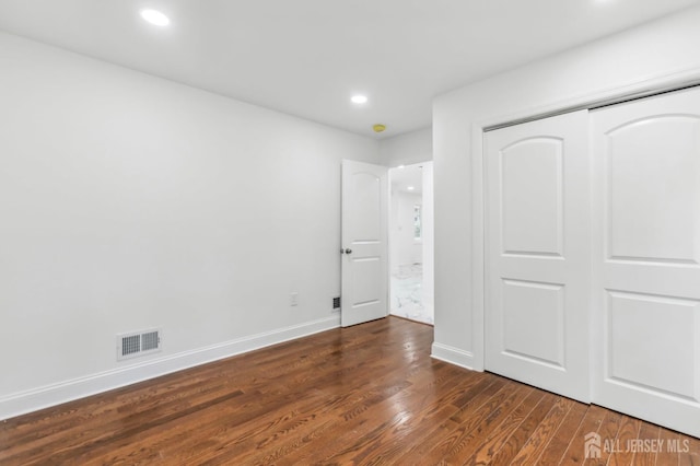 244 Lloyd Rd, Matawan, NJ 07747 - unfurnished bedroom with dark wood-style floors, recessed lighting, baseboards, and a closet