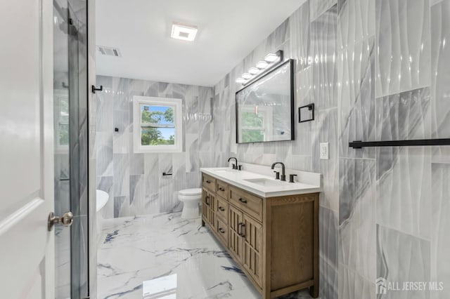 244 Lloyd Rd, Matawan, NJ 07747 - bathroom with tile walls, double vanity, marble tiled floors, a shower, and toilet
