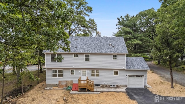 244 Lloyd Rd, Matawan, NJ 07747 - rear view of property with a garage, driveway, and roof with shingles