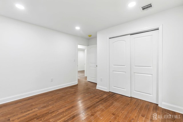 244 Lloyd Rd, Matawan, NJ 07747 - unfurnished bedroom with hardwood / wood-style floors, baseboards, a closet, and recessed lighting