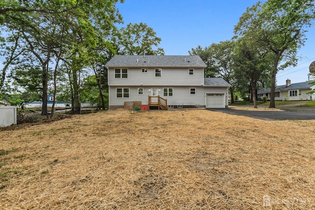 244 Lloyd Rd, Matawan, NJ 07747 - rear view of house featuring a garage and asphalt driveway