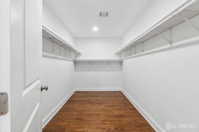 244 Lloyd Rd, Matawan, NJ 07747 - spacious closet with dark wood-style flooring