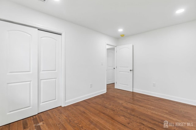 244 Lloyd Rd, Matawan, NJ 07747 - unfurnished bedroom with baseboards, wood finished floors, recessed lighting, and a closet