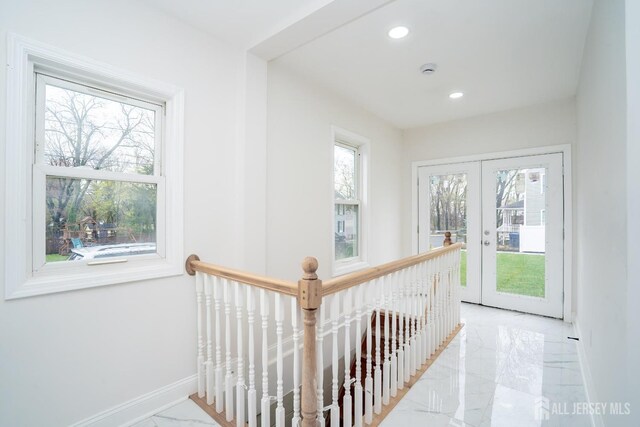 hallway featuring baseboards, marble finish floor, an upstairs landing, and recessed lighting