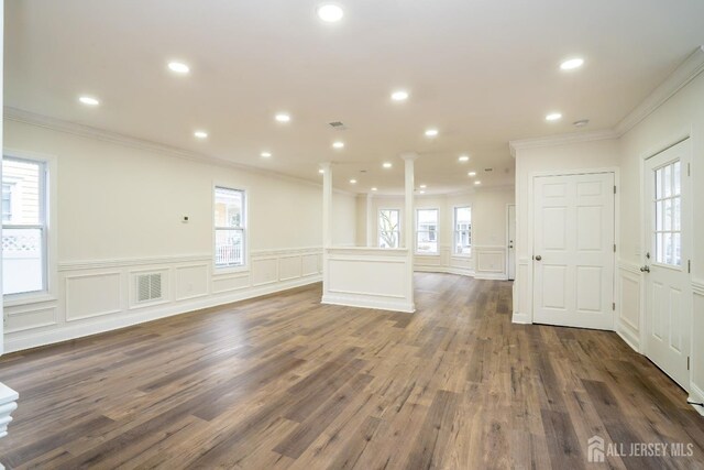 entrance foyer featuring ornate columns, visible vents, recessed lighting, and dark wood-type flooring