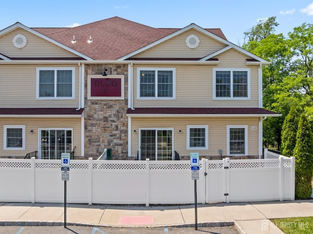 32 Cinder Rd Unit 22, Edison, NJ 08820 - view of front of home with a gate, stone siding, and a shingled roof