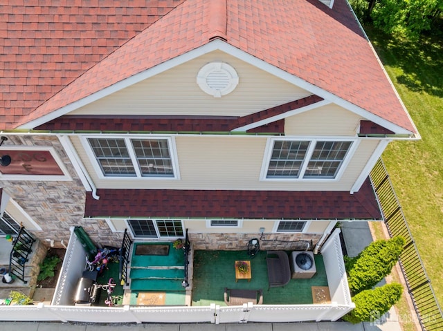 32 Cinder Rd Unit 22, Edison, NJ 08820 - view of front facade with a fenced front yard, stone siding, and a shingled roof