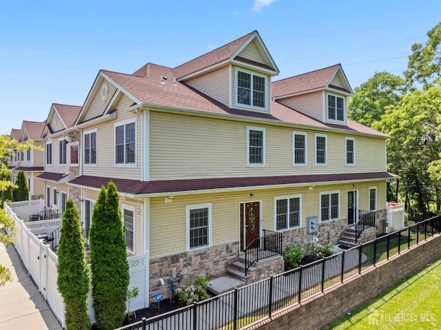 32 Cinder Rd Unit 22, Edison, NJ 08820 - view of front of house featuring stone siding and a fenced backyard