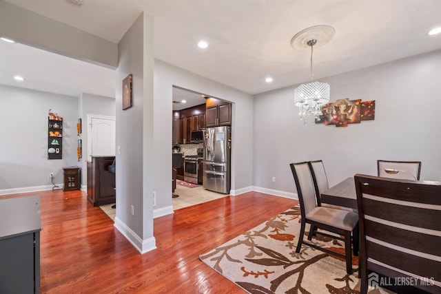 32 Cinder Rd Unit 22, Edison, NJ 08820 - dining area featuring light wood finished floors, a chandelier, and recessed lighting