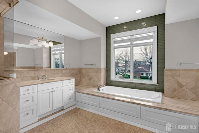 full bath with vanity, tile patterned flooring, recessed lighting, and a bath