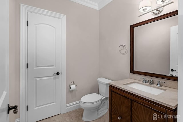 bathroom with tile patterned flooring, vanity, baseboards, toilet, and ornamental molding