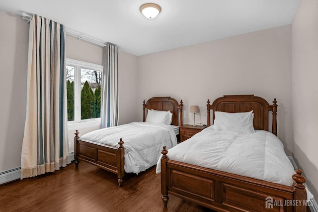 bedroom featuring dark wood finished floors and a baseboard radiator