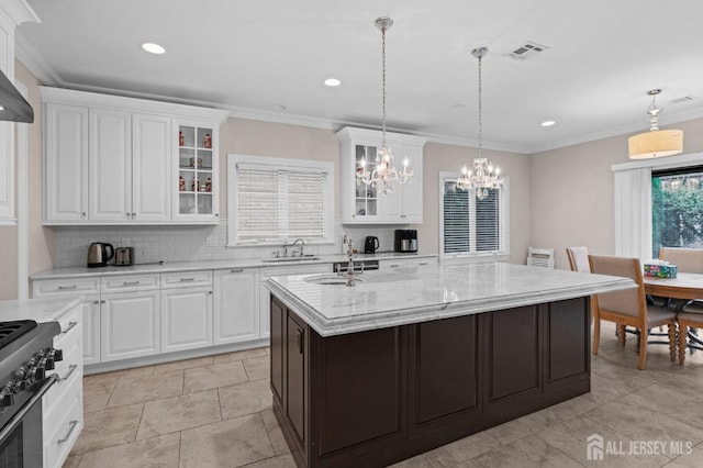 kitchen with white cabinets, an inviting chandelier, a sink, and visible vents