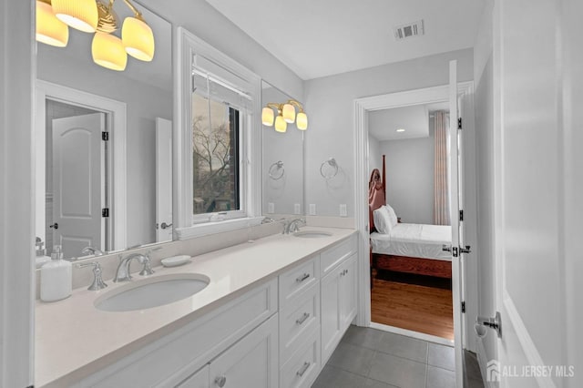 bathroom featuring a sink, tile patterned floors, double vanity, and visible vents