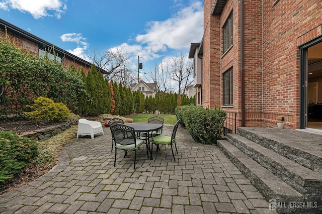 view of patio featuring outdoor dining area