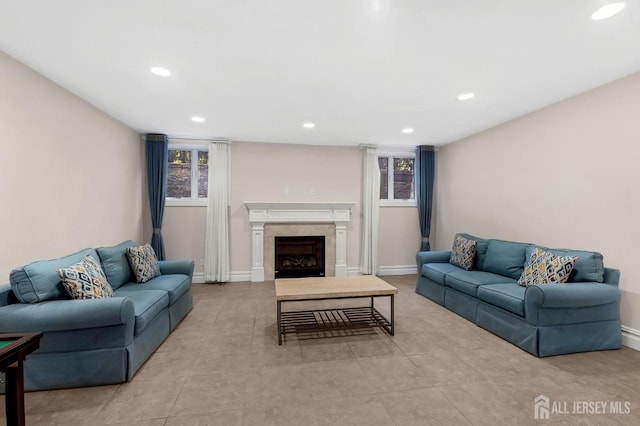 living area featuring recessed lighting, plenty of natural light, light tile patterned floors, and a fireplace