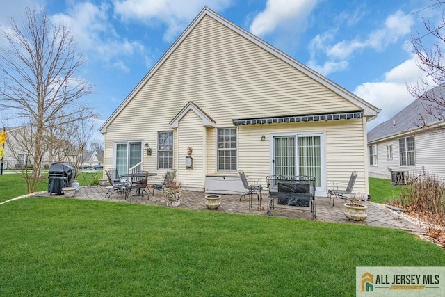 back of property with a patio, central air condition unit, and a yard