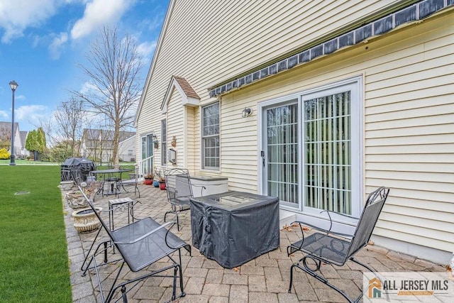 view of patio / terrace with area for grilling and a hot tub