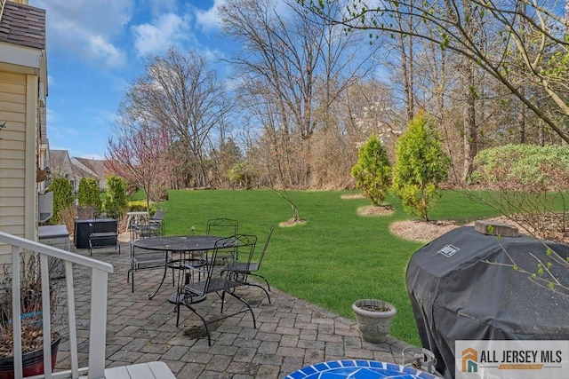 exterior space featuring a grill and outdoor dining space