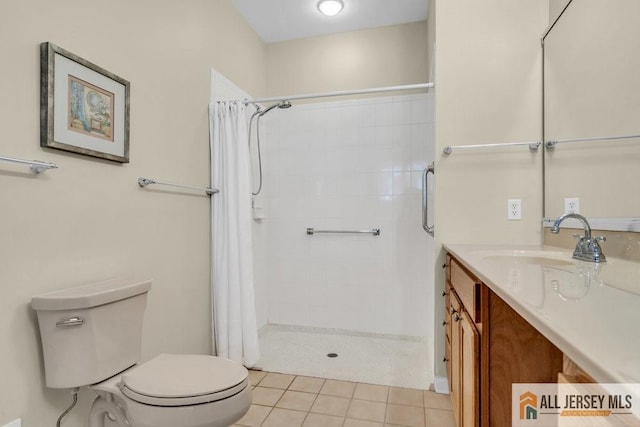 bathroom with tile patterned flooring, toilet, a stall shower, and vanity