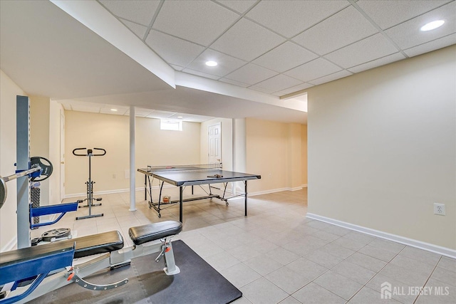 workout area featuring recessed lighting, baseboards, and a paneled ceiling