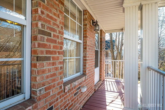 wooden terrace featuring covered porch