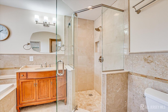 bathroom with tile walls and a stall shower