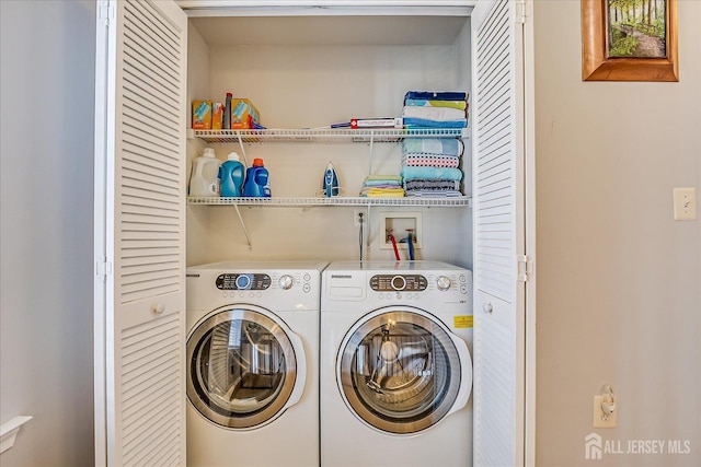 laundry room with washing machine and clothes dryer and laundry area