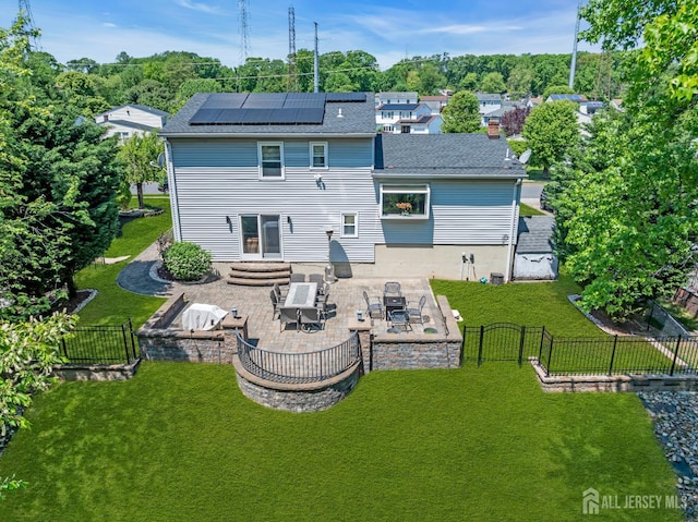 42 Ridge Rd, Edison, NJ 08817 - rear view of property featuring solar panels, a patio, an outdoor fire pit, and a shingled roof