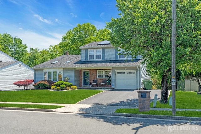 42 Ridge Rd, Edison, NJ 08817 - traditional home featuring solar panels, asphalt driveway, a front yard, and an attached garage