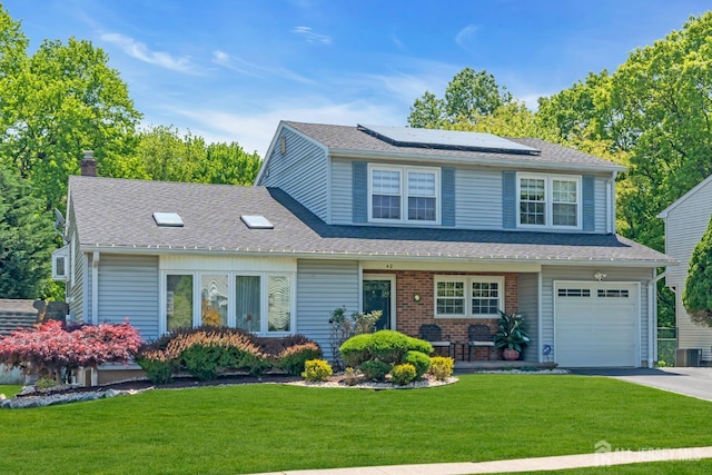 42 Ridge Rd, Edison, NJ 08817 - view of front of property featuring roof mounted solar panels, a front lawn, asphalt driveway, a chimney, and covered porch