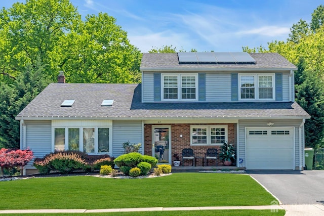 42 Ridge Rd, Edison, NJ 08817 - view of front of property with roof mounted solar panels, a front yard, asphalt driveway, a chimney, and an attached garage