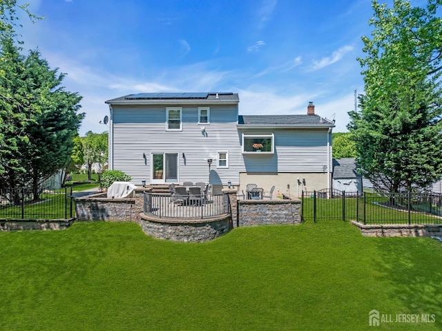 42 Ridge Rd, Edison, NJ 08817 - rear view of house with solar panels, a patio, a chimney, and exterior kitchen