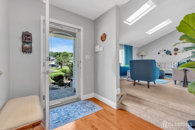 42 Ridge Rd, Edison, NJ 08817 - entrance foyer featuring plenty of natural light, a skylight, wood finished floors, vaulted ceiling, and baseboards