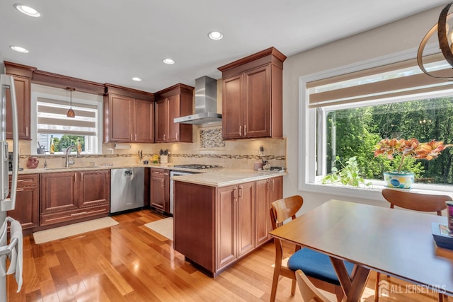 42 Ridge Rd, Edison, NJ 08817 - kitchen featuring wall chimney range hood, stainless steel dishwasher, a sink, light wood-style floors, and decorative backsplash