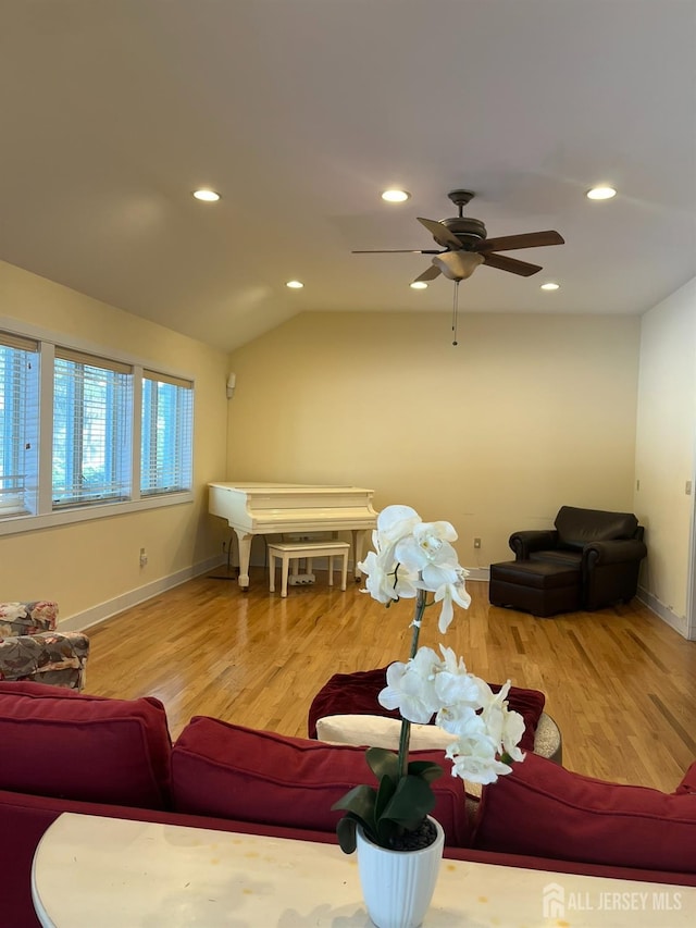 living room with lofted ceiling, wood finished floors, and recessed lighting