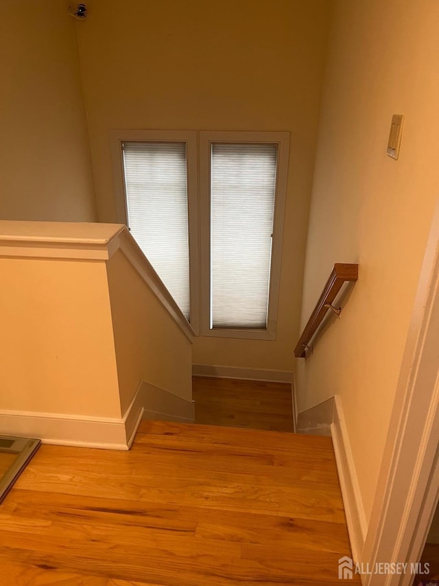 stairs featuring baseboards and wood finished floors