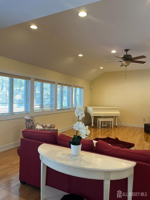 living area featuring recessed lighting, vaulted ceiling, baseboards, and wood finished floors