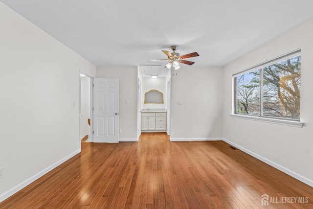 unfurnished bedroom with ceiling fan and light hardwood / wood-style flooring