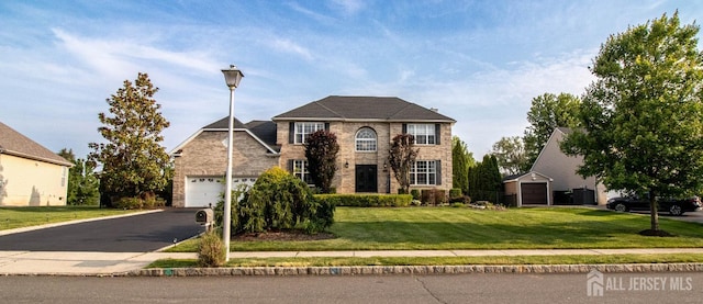 29 Mitchell Dr, Monroe, NJ 08831 - view of front of property with stone siding, driveway, an attached garage, and a front lawn