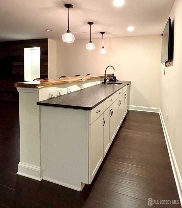 29 Mitchell Dr, Monroe, NJ 08831 - kitchen featuring dark countertops, a peninsula, dark wood-type flooring, white cabinetry, and recessed lighting
