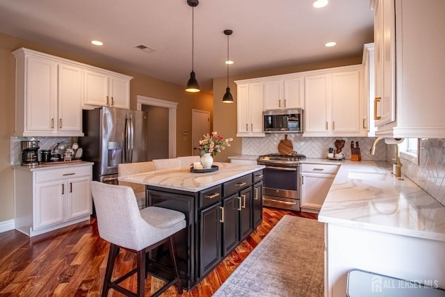 29 Mitchell Dr, Monroe, NJ 08831 - kitchen with stainless steel appliances, white cabinets, decorative backsplash, a kitchen island, and pendant lighting